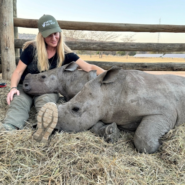 Jamie with baby rhino orphans, David and Jonathan
